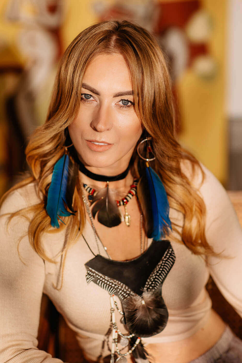 Iwona Michalska — portret Iwony Michalskiej w stylu boho z piórami i naszyjnikami.